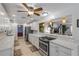 Galley kitchen with stone countertops, stainless steel appliances, tile backsplash, and bright lighting at 921 Duncan Rd, South Daytona, FL 32119