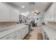 Bright kitchen features white cabinets, granite countertops, modern appliances and flows into the dining area at 921 Duncan Rd, South Daytona, FL 32119
