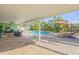 Beautiful covered patio offers shaded seating and scenic views of the pool and backyard oasis at 921 Duncan Rd, South Daytona, FL 32119