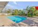 Backyard pool with a small fountain feature and surrounding foliage at 921 Duncan Rd, South Daytona, FL 32119