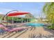 Inviting pool and sun loungers set amongst a beautifully landscaped backyard at 921 Duncan Rd, South Daytona, FL 32119