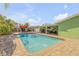 Backyard pool with surrounding brickwork, complemented by the covered outdoor patio at 921 Duncan Rd, South Daytona, FL 32119