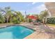 Enjoy the beautiful pool and surrounding yard with lounge seating and a red umbrella at 921 Duncan Rd, South Daytona, FL 32119