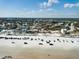 An aerial view of a beach town with homes, sandy beach and ocean in the distance at 921 N Atlantic Ave, New Smyrna Beach, FL 32169