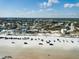 An aerial view of a beach town with homes, sandy beach, and ocean in the distance at 921 N Atlantic Ave, New Smyrna Beach, FL 32169