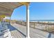 Inviting back porch with porch swing and ocean views, perfect for relaxing at 921 N Atlantic Ave, New Smyrna Beach, FL 32169