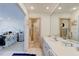 Bright bathroom featuring dual sinks, a shower with a colorful curtain, and an adjoining bedroom at 921 N Atlantic Ave, New Smyrna Beach, FL 32169