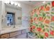 Cozy bathroom with vibrant tropical accents, bright lighting, and a separate shower at 921 N Atlantic Ave, New Smyrna Beach, FL 32169