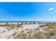 Beautiful beach view with sand dunes and blue skies, showcasing the property's desirable location at 921 N Atlantic Ave, New Smyrna Beach, FL 32169