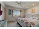 Bright bedroom with a ceiling fan, floral accents, and beach views from the windows at 921 N Atlantic Ave, New Smyrna Beach, FL 32169