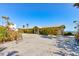 Exterior shot of the house with a large driveway and tropical landscaping at 921 N Atlantic Ave, New Smyrna Beach, FL 32169
