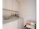Efficient laundry room with washer, dryer, and storage cabinets at 921 N Atlantic Ave, New Smyrna Beach, FL 32169