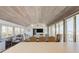 Spacious living room with vaulted ceilings, floor-to-ceiling windows, and comfortable seating arrangements at 921 N Atlantic Ave, New Smyrna Beach, FL 32169