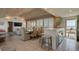 Open-concept living area features a dining table and seamless beach views through expansive windows at 921 N Atlantic Ave, New Smyrna Beach, FL 32169