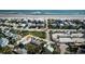 Aerial view of a blue home near the beach, with a marked path to a beach walkover at 923 Locust St, New Smyrna Beach, FL 32169