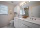 Bright bathroom features double sinks, a neutral color scheme, and cabinet space at 923 Locust St, New Smyrna Beach, FL 32169
