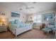 Serene bedroom with a king-size bed, coastal-themed decor, ample natural light, and wood flooring at 923 Locust St, New Smyrna Beach, FL 32169