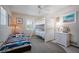 Charming bedroom featuring bunk beds, a twin bed, nautical decor, and natural light from the window at 923 Locust St, New Smyrna Beach, FL 32169