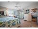 Bright, airy bedroom with a king-size bed, coastal decor, wood floors, and natural light from the window at 923 Locust St, New Smyrna Beach, FL 32169
