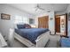 Nautical-themed bedroom with blue bedding, ceiling fan, and tiled flooring at 923 Locust St, New Smyrna Beach, FL 32169