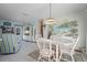 Charming dining area with white table and chairs, complemented by a coastal mural and stylish decor at 923 Locust St, New Smyrna Beach, FL 32169