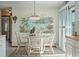 Charming dining area features a decorative tropical mural and white wood table set at 923 Locust St, New Smyrna Beach, FL 32169