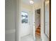 Bright entryway showcasing a white front door with glass, tile flooring, and a staircase visible through an open door at 923 Locust St, New Smyrna Beach, FL 32169