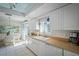 Bright kitchen features white cabinetry and adjacent dining space with a decorative mural at 923 Locust St, New Smyrna Beach, FL 32169