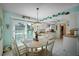 Bright kitchen and dining area with white cabinets and access to outdoor patio at 923 Locust St, New Smyrna Beach, FL 32169