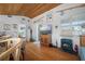 Cozy living room with wood floors, sliding glass doors, tongue and groove ceiling, and nautical decor at 923 Locust St, New Smyrna Beach, FL 32169