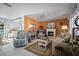 Bright living room with beach-themed decor, fireplace, comfortable seating, and access to the dining area at 923 Locust St, New Smyrna Beach, FL 32169