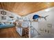 Living room featuring a wet bar, sofa, daybed, wood plank ceiling, nautical decor, and staircase at 923 Locust St, New Smyrna Beach, FL 32169
