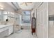 Bathroom featuring a shower, tub, vanity, and a large window allowing natural light to illuminate the space at 936 Countryside West Blvd, Port Orange, FL 32127