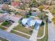 Aerial view of a house in a neighborhood and highlights the well-maintained lawn, driveway, and landscaping at 950 Sand Crest Dr, Port Orange, FL 32127