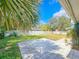 Spacious backyard with a stone patio, lush greenery, privacy fence, and mature trees at 950 Sand Crest Dr, Port Orange, FL 32127