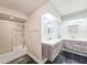 This bathroom features double sinks, updated fixtures, and a tub with shower at 950 Sand Crest Dr, Port Orange, FL 32127