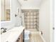This renovated bathroom features a tiled shower and updated vanity at 950 Sand Crest Dr, Port Orange, FL 32127