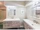 This bathroom features double sinks, updated fixtures, and a glass door shower at 950 Sand Crest Dr, Port Orange, FL 32127