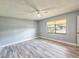 This bedroom features light gray walls, a ceiling fan, and a large window at 950 Sand Crest Dr, Port Orange, FL 32127