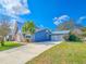 Unique home featuring a metal roof, stone accents and a long driveway at 950 Sand Crest Dr, Port Orange, FL 32127