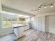 Kitchen featuring white cabinets, island, and stainless steel dishwasher at 950 Sand Crest Dr, Port Orange, FL 32127