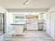 Bright kitchen features white cabinets, island, and stainless steel dishwasher at 950 Sand Crest Dr, Port Orange, FL 32127