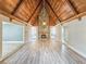 Spacious living room boasts a stone fireplace and wood ceiling at 950 Sand Crest Dr, Port Orange, FL 32127