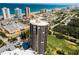 Aerial view showcases a high-rise condo with waterfront views, golf course, and city landscape at 1 Oceans West Blvd # 6A5, Daytona Beach, FL 32118