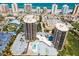 This is an aerial view of a condominium complex with parking, tennis, pool, and putting green at 1 Oceans West Blvd # 6A5, Daytona Beach, FL 32118