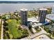 This is an aerial shot of two high-rise condominium buildings with a swimming pool, golf course and water views at 1 Oceans West Blvd # 6A5, Daytona Beach, FL 32118