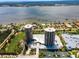 Elevated view highlights waterfront condos with a pool, landscaping, and proximity to water at 1 Oceans West Blvd # 6A5, Daytona Beach, FL 32118