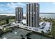 Aerial view showcases tennis courts, parking lot, and waterfront condo towers with stunning views at 1 Oceans West Blvd # 6A5, Daytona Beach, FL 32118