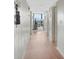 View of a hallway with hardwood floors leading to a bright living space with large windows at 1 Oceans West Blvd # 6A5, Daytona Beach, FL 32118