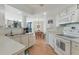 Well-lit kitchen with a view into the dining area, complete with updated appliances and cabinetry at 1 Oceans West Blvd # 6A5, Daytona Beach, FL 32118